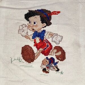 Pinocchio hand Embroidered Character Design on natural fabric